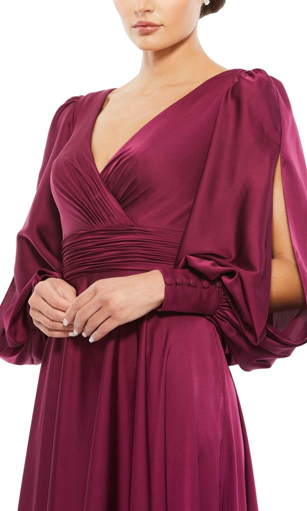 A person models the Mac Duggal Long Formal Dress 67847—deep magenta satin with long sleeves, a V-neckline, and ruched waist—against a white background.